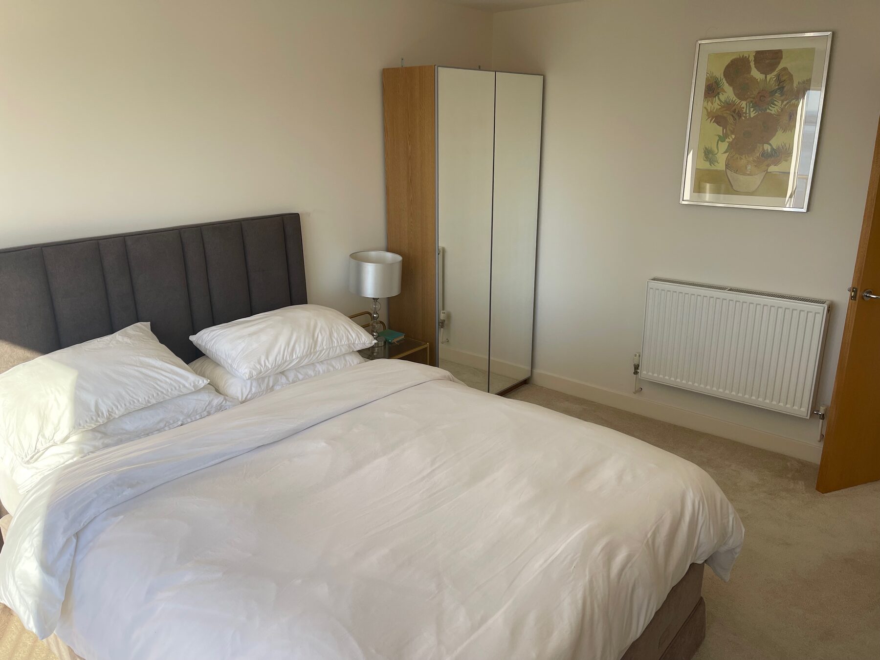 The Channel Room bed, sea view through the Juliet balcony window