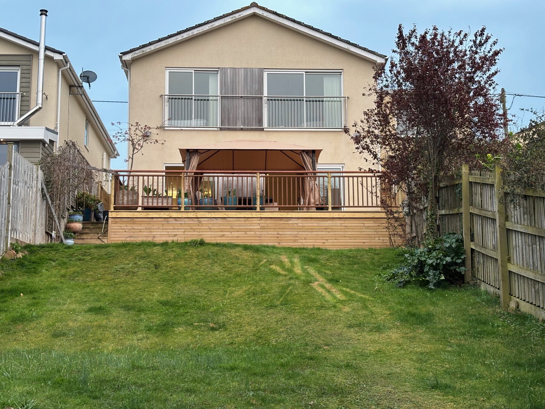 Back of the house with garden deck and gazebo